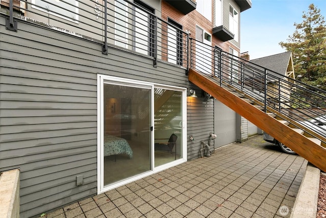 exterior space featuring stairs and a patio