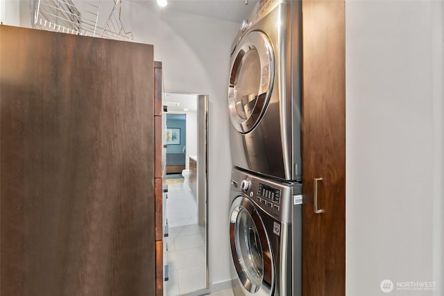 clothes washing area featuring stacked washer and dryer and laundry area