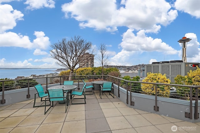 view of patio / terrace featuring a water view and outdoor dining space