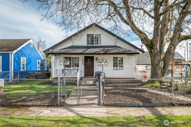 bungalow-style house with a porch, a fenced front yard, and a gate