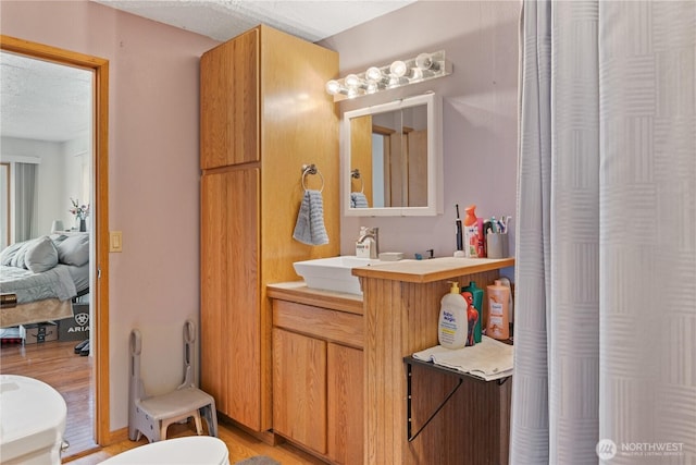 bathroom with a textured ceiling and vanity