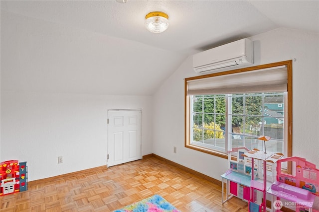 playroom with lofted ceiling, baseboards, a textured ceiling, and a wall mounted AC