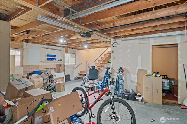 basement featuring a garage and stairway