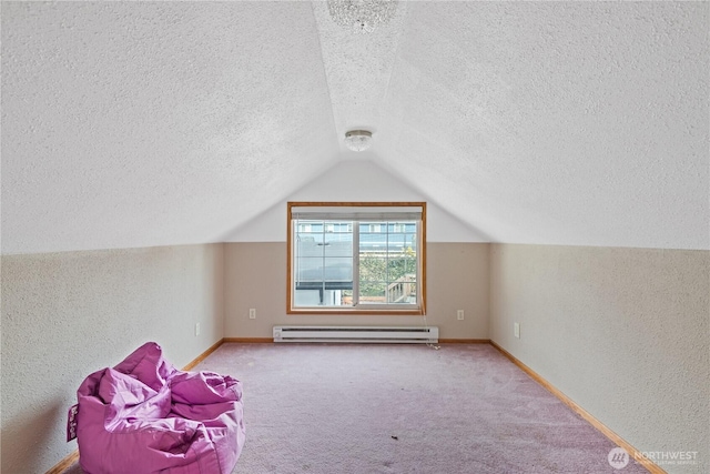 bonus room featuring a baseboard heating unit, carpet flooring, vaulted ceiling, and baseboards