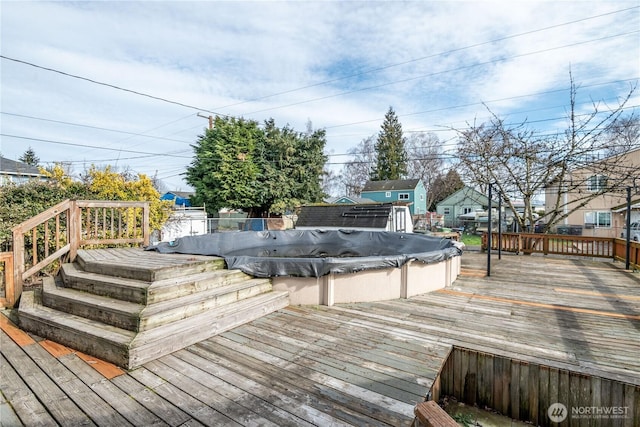 wooden terrace with a covered pool