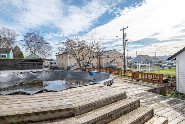 wooden terrace featuring a residential view