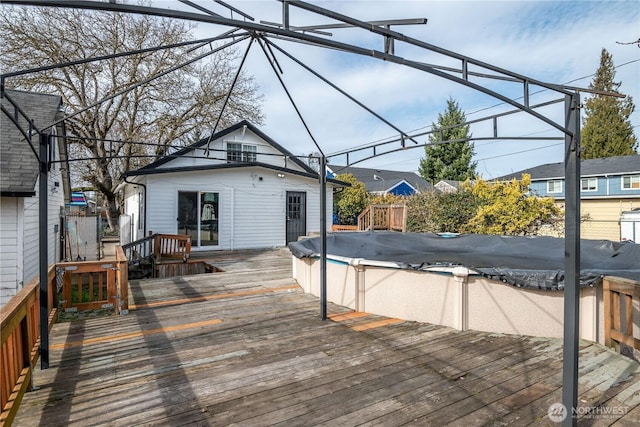 wooden terrace featuring a covered pool