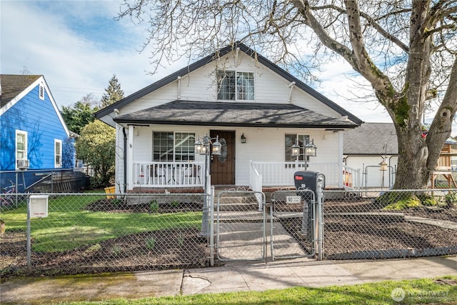 bungalow-style house with a fenced front yard, a porch, a shingled roof, a front yard, and a gate