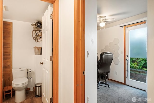 bathroom featuring baseboards, toilet, and a ceiling fan