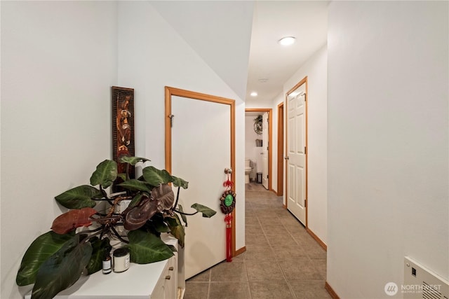 hall with recessed lighting, baseboards, and light tile patterned flooring