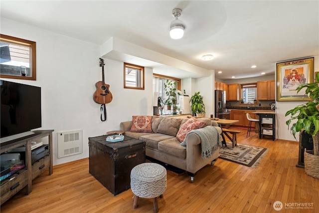 living room with light wood-style flooring, a wealth of natural light, and recessed lighting