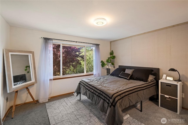 bedroom with light carpet and baseboards