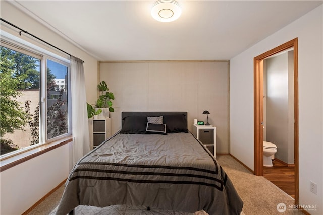 carpeted bedroom featuring baseboards