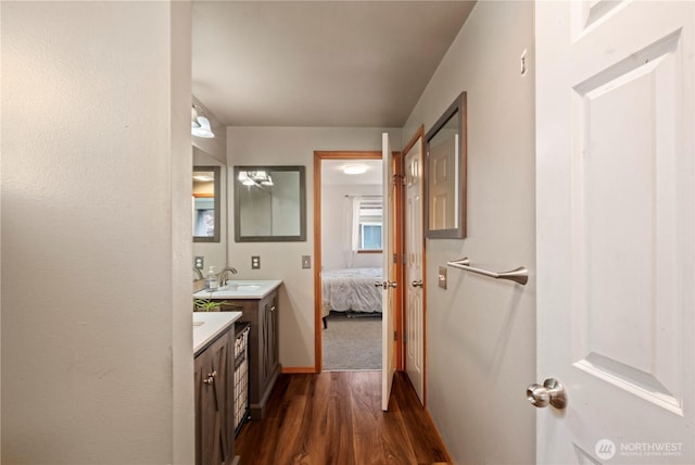 bathroom with connected bathroom, vanity, and wood finished floors