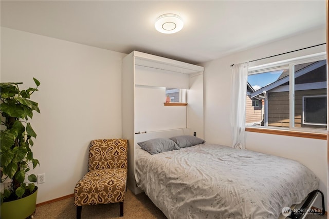 bedroom featuring carpet flooring and baseboards