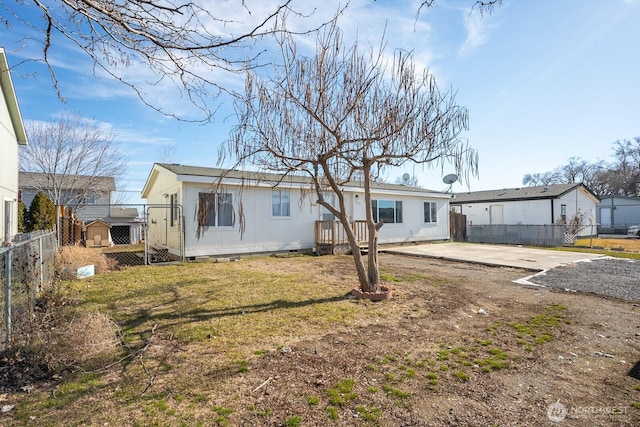 view of front of home with crawl space, a patio area, fence, and a front lawn