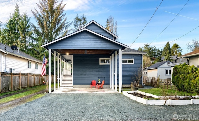 view of front of house with driveway, stairs, fence, and an attached carport