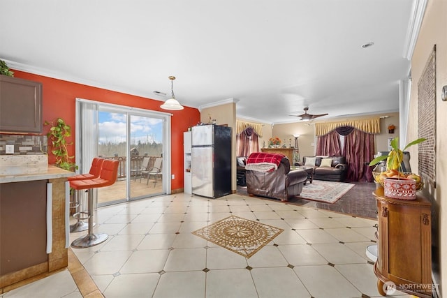 living room with ceiling fan, ornamental molding, and light tile patterned flooring