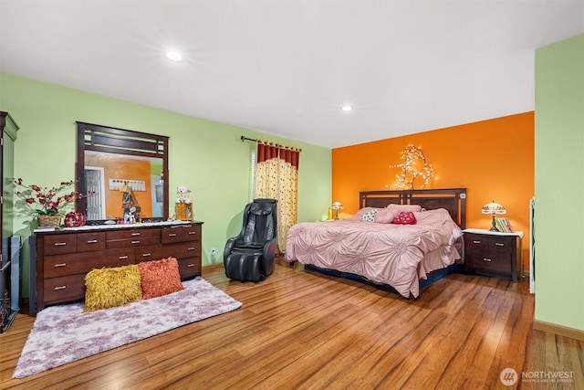 bedroom with baseboards, wood finished floors, and recessed lighting