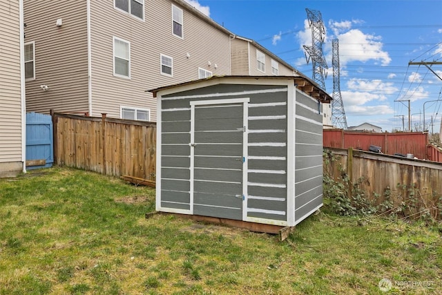 view of shed with a fenced backyard