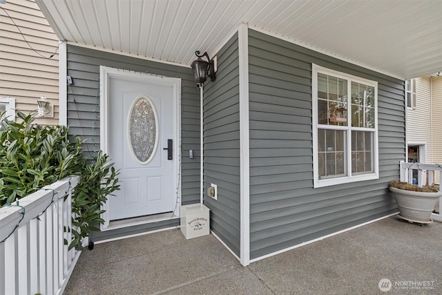 view of exterior entry with a porch