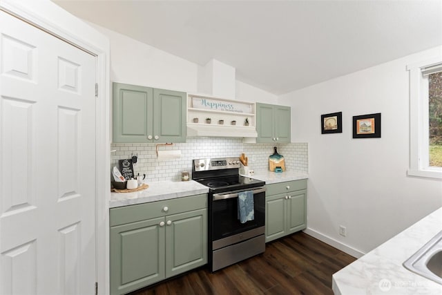 kitchen with lofted ceiling, light countertops, stainless steel range with electric cooktop, green cabinets, and backsplash