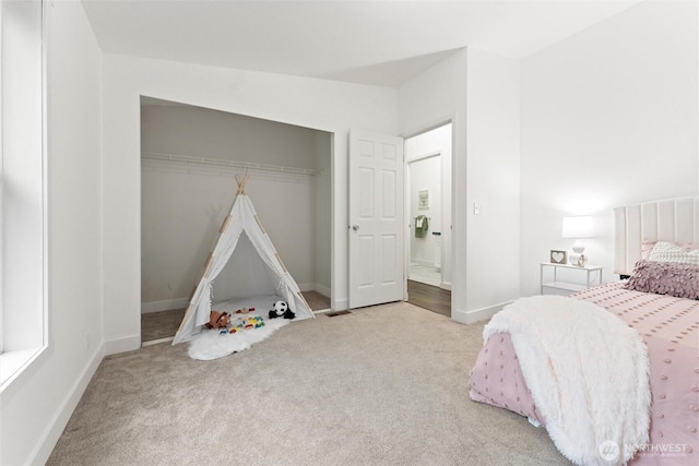 bedroom featuring carpet, a closet, and baseboards