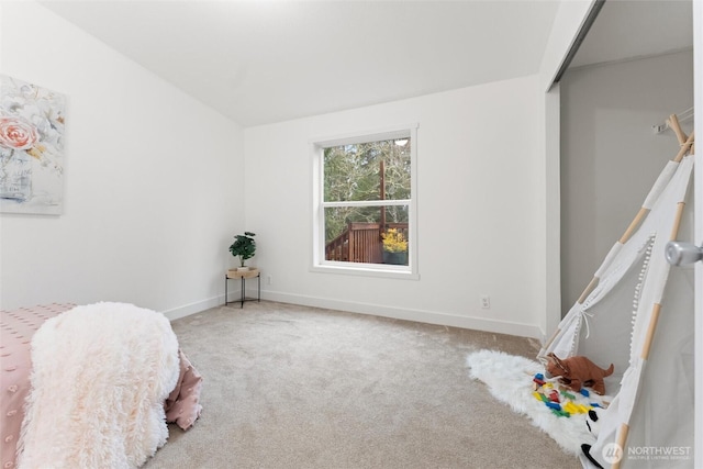 bedroom with carpet floors and baseboards