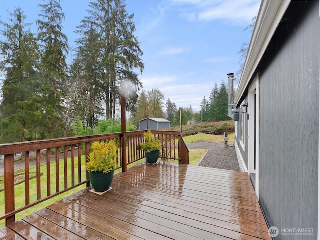 wooden terrace featuring an outdoor structure