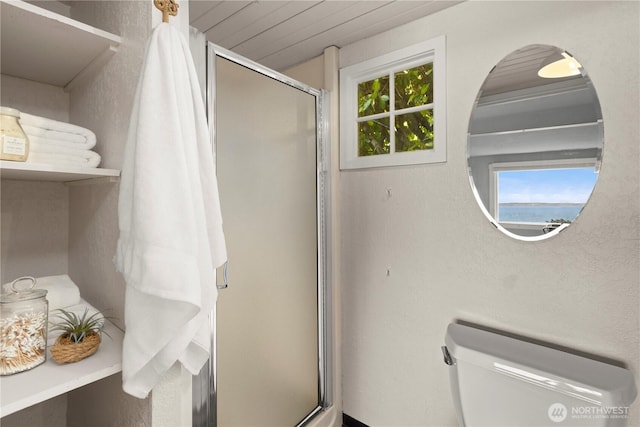 full bathroom with a shower stall and toilet