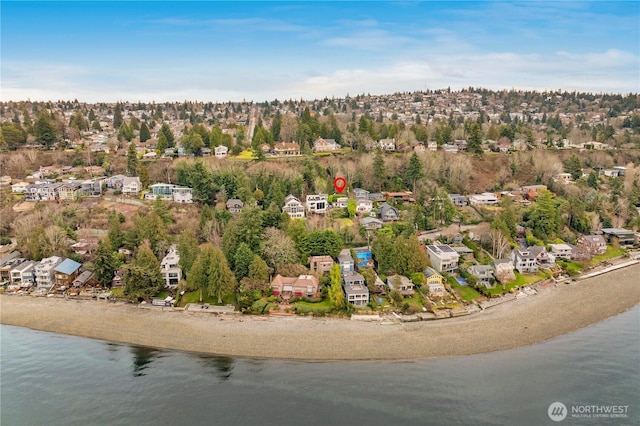 drone / aerial view with a water view, a residential view, and a beach view