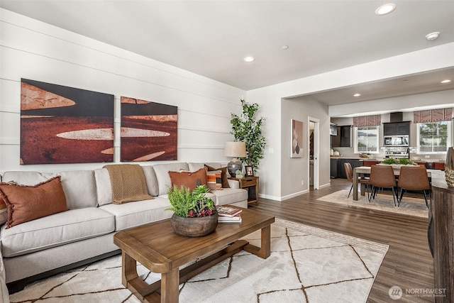 living area featuring recessed lighting, baseboards, and wood finished floors