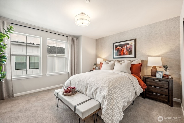 bedroom featuring light colored carpet, baseboards, and wallpapered walls