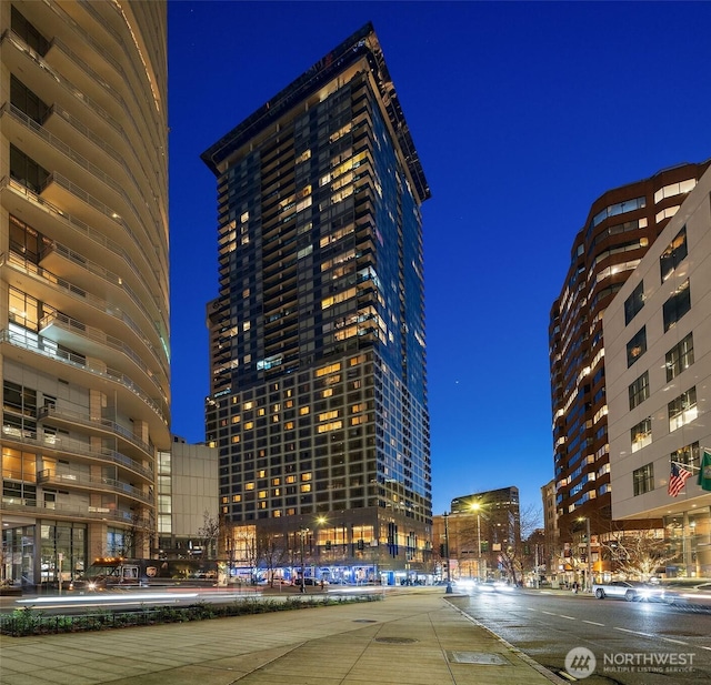 property at night with a view of city lights