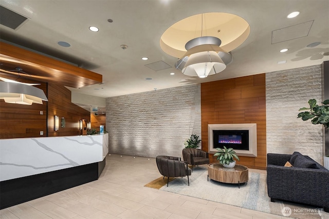 reception area featuring visible vents and a glass covered fireplace