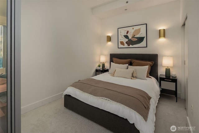 bedroom featuring light carpet and baseboards