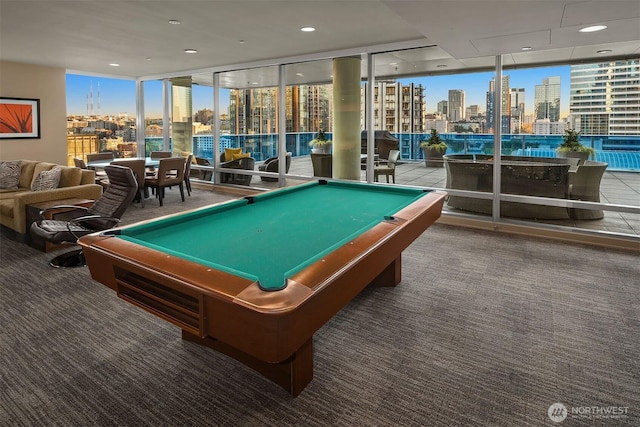 playroom with pool table, a wall of windows, carpet, and a city view