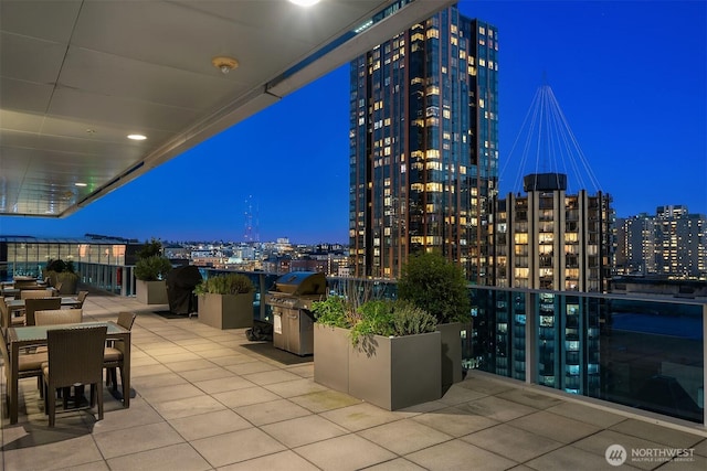 patio at twilight with a view of city lights and outdoor dining space