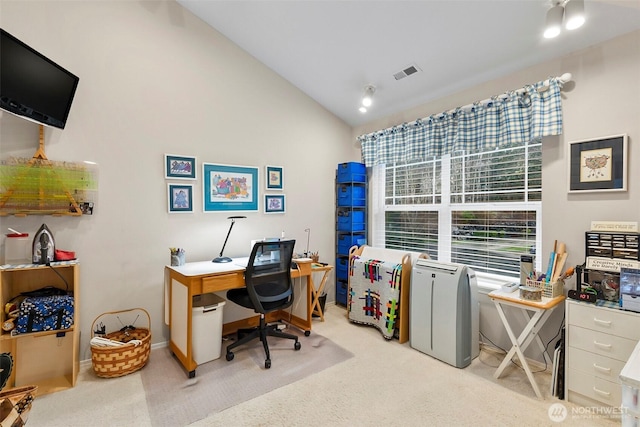 office space featuring light colored carpet, visible vents, vaulted ceiling, and baseboards