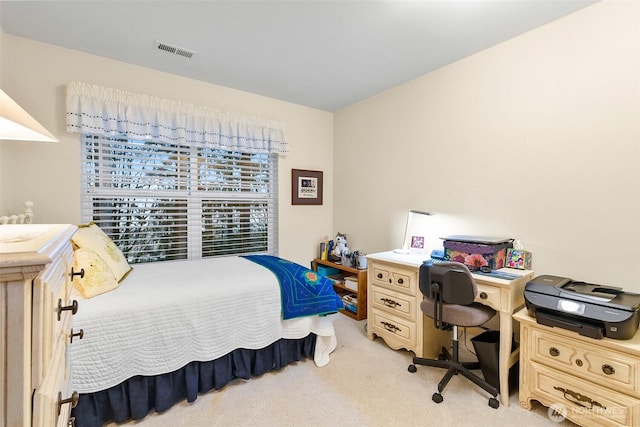 bedroom with visible vents and light carpet