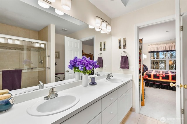 bathroom featuring double vanity, ensuite bath, a sink, and tile patterned floors