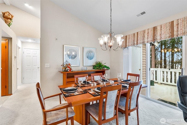 dining room featuring light carpet, visible vents, and a wealth of natural light