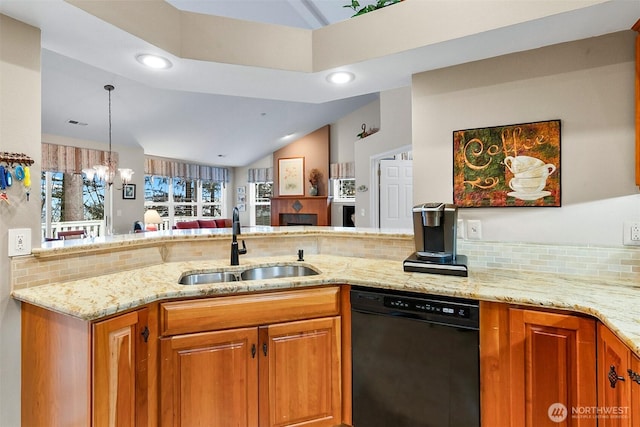 kitchen featuring a sink, tasteful backsplash, brown cabinetry, and dishwasher