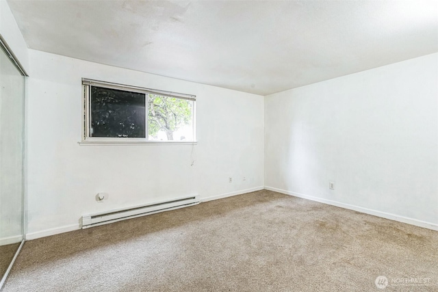 carpeted empty room with baseboards and baseboard heating