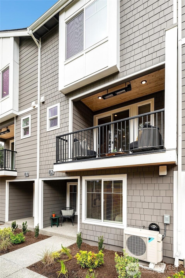 rear view of house with ac unit and a patio area