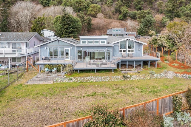 back of house with a deck, stairs, a fenced backyard, and a lawn