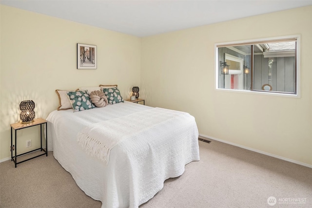 carpeted bedroom with visible vents and baseboards