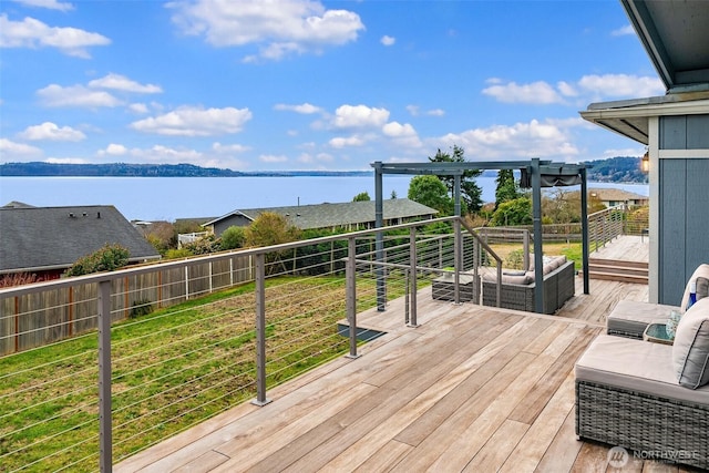 wooden terrace with outdoor lounge area and a water view