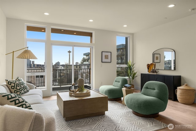 living room featuring recessed lighting, a view of city, and wood finished floors