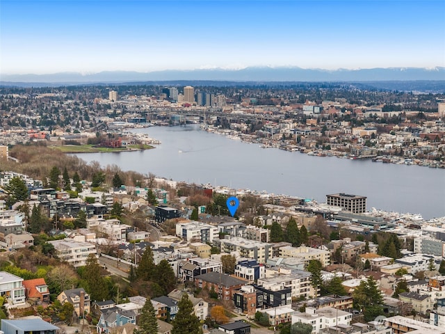 birds eye view of property featuring a water view and a city view